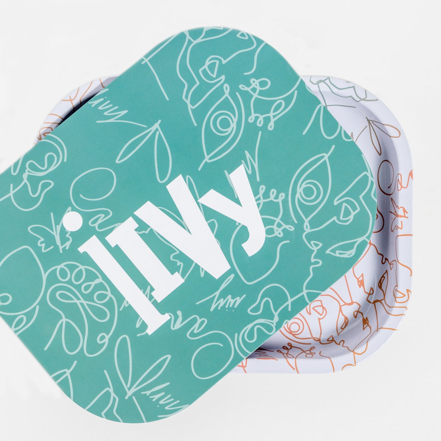 White rolling tray with gradient colour pattern. Teal with white pattern and iivy written on it. The teal lid is on top of the tray, slightly askew. 